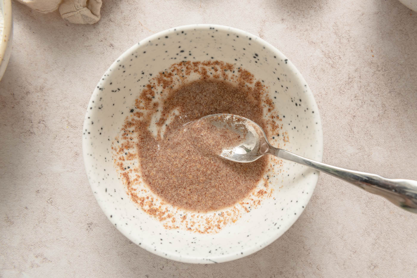 Ground flaxseed mixed with water in a small dish to form a gel-like flax 