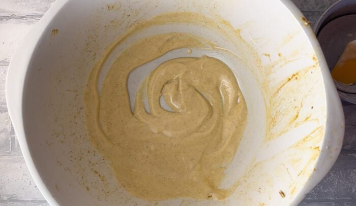 A creamy yogurt dressing in a large mixing bowl.