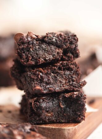 A stack of 3 zucchini brownies with chocolate chips in them.
