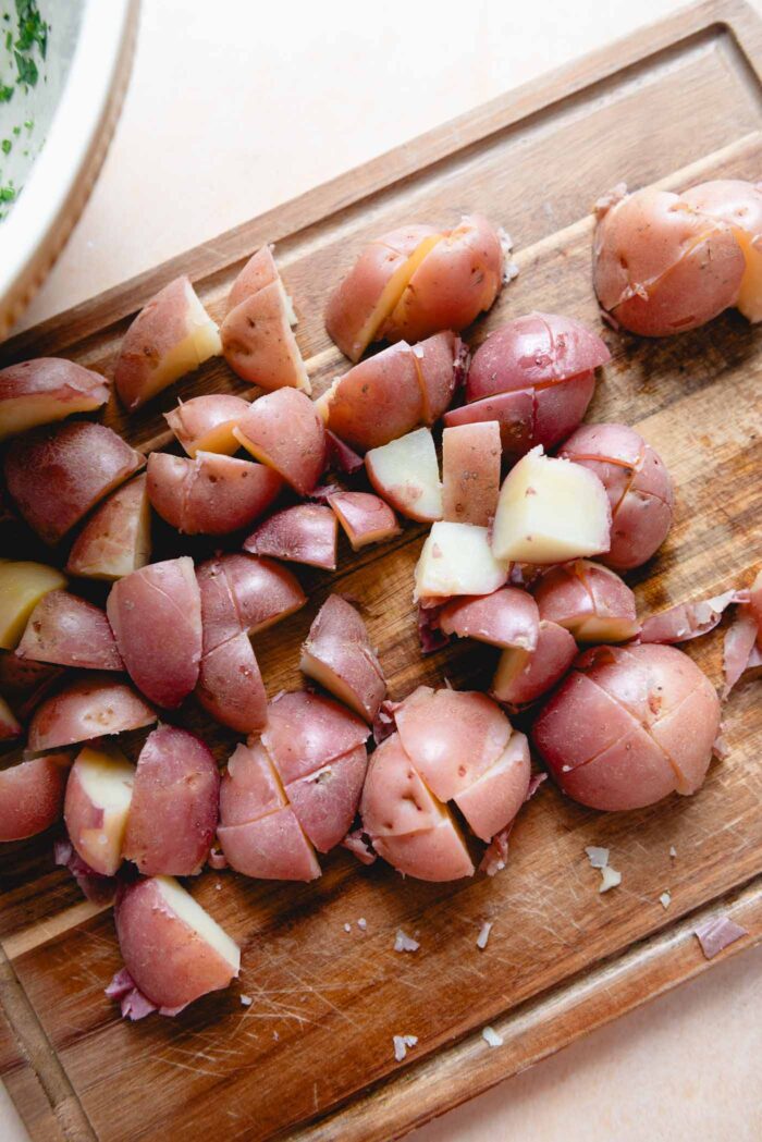Sliced red potatoes on a cutting board.