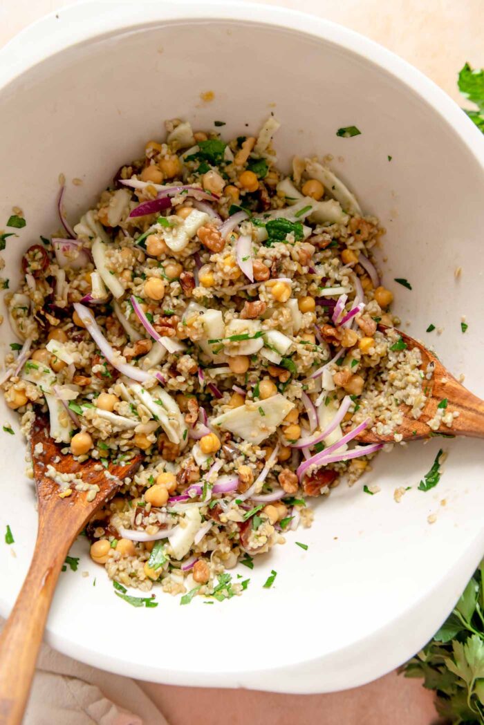 Freekeh salad with fennel, chickpeas, dates and red onion in a bowl.