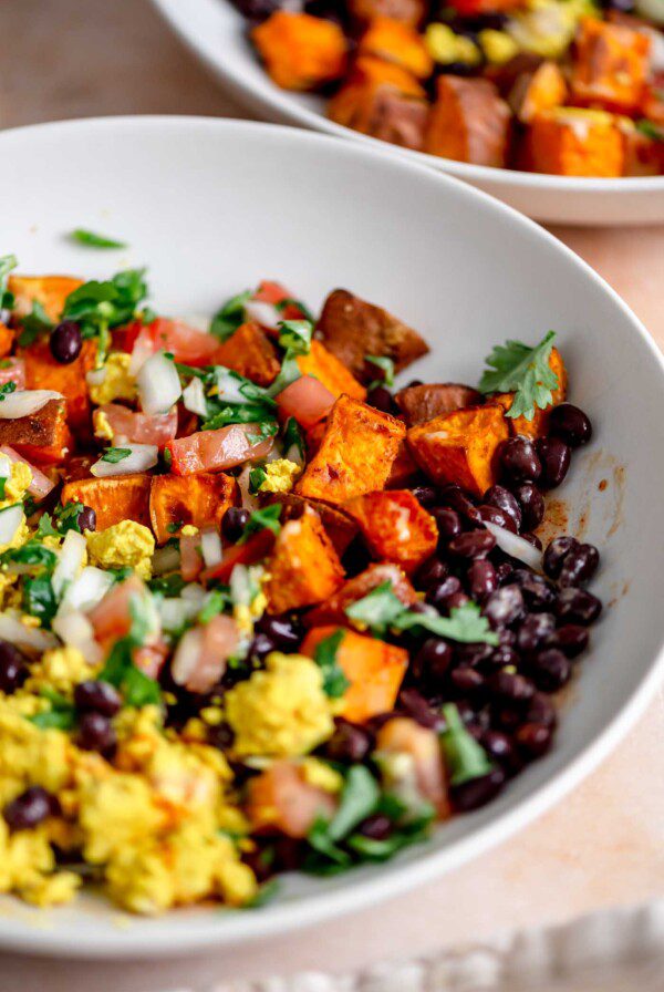 Breakfast burrito bowl with tofu scramble, black beans, roasted sweet potato and salsa all mixed together.