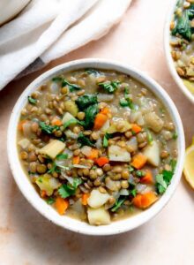 Bowl of a hearty stew made with lentils, carrot and potato.