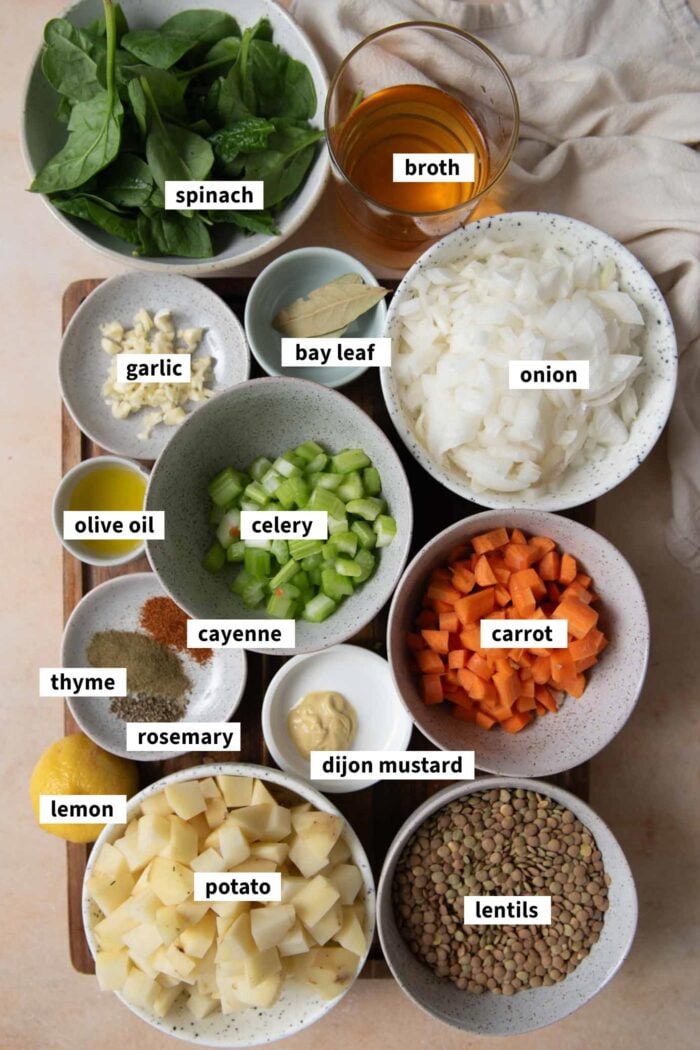 Ingredients for vegan lentil stew recipe with potato, carrot, spinach and celery.