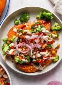 Baked sweet potato topped with chickpeas, broccoli, red onion and tahini sauce.