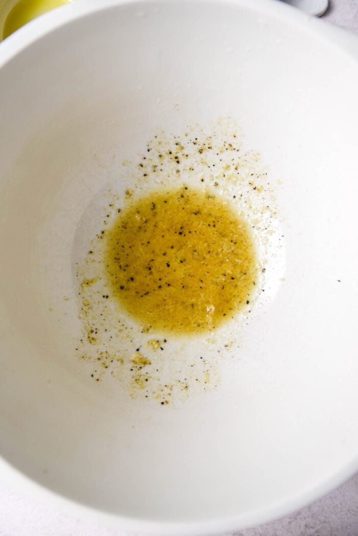 Olive oil vinaigrette in a mixing bowl.
