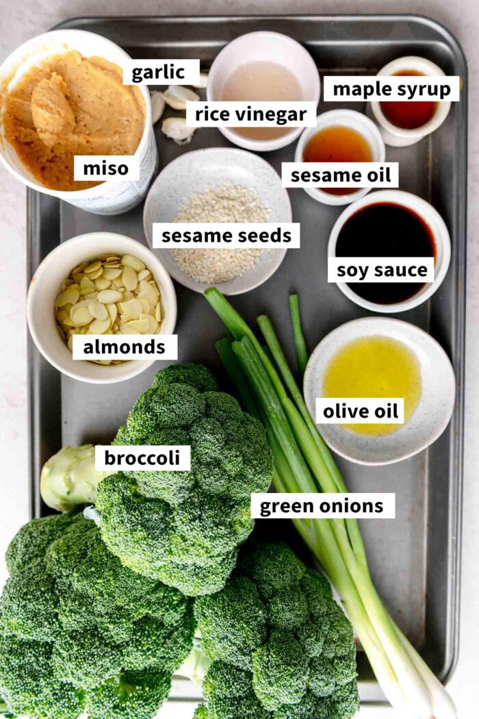 Ingredients for a miso roasted broccoli salad with almonds, sesame seeds and green onions.