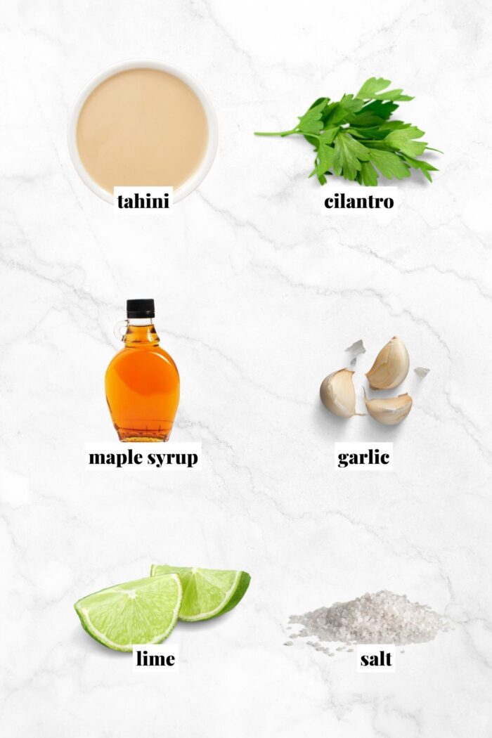 All the ingredients for making a creamy tahini sauce recipe with lime, cilantro and maple syrup.