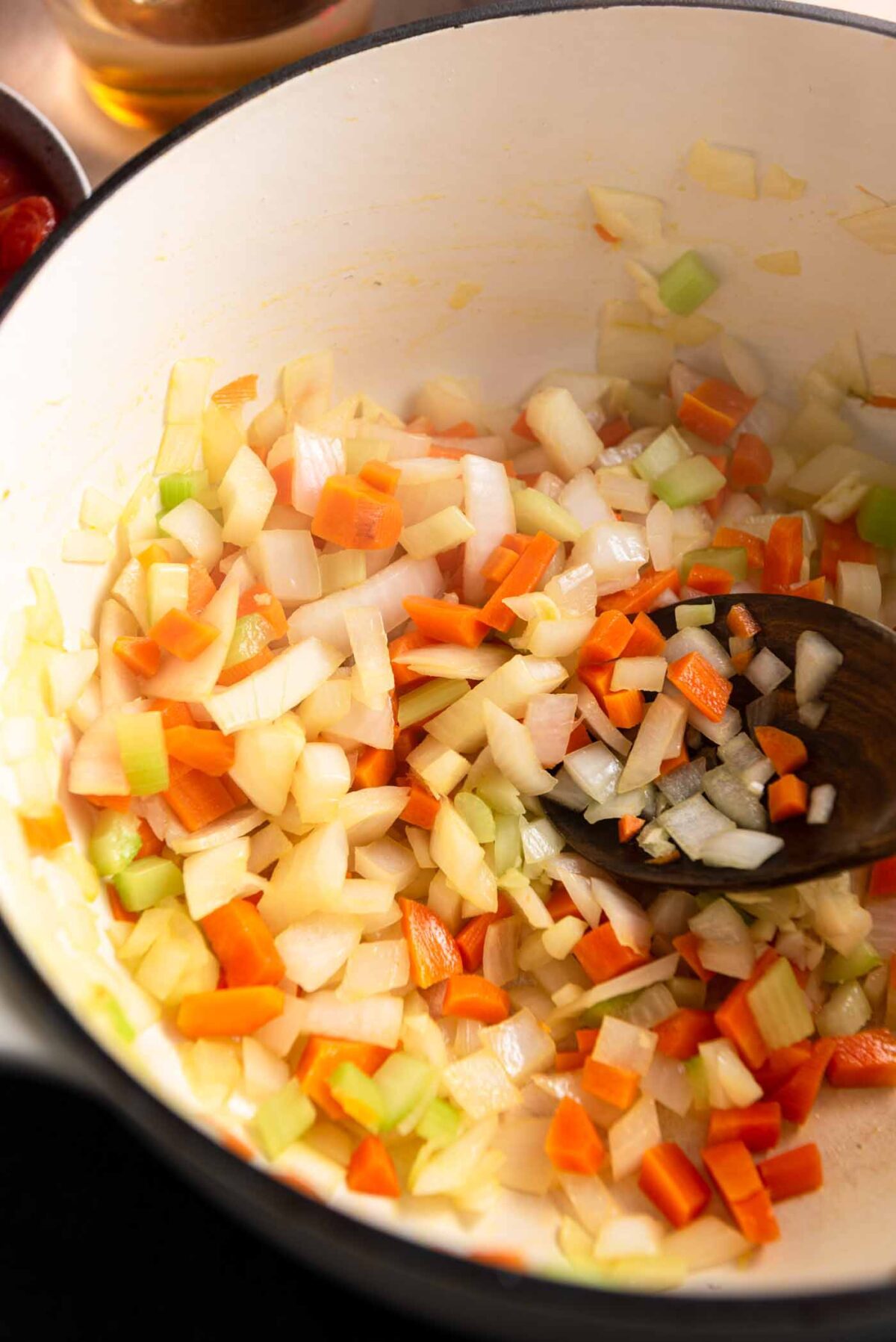 Carrot, onion, celery and garlic cooking in a soup pot.