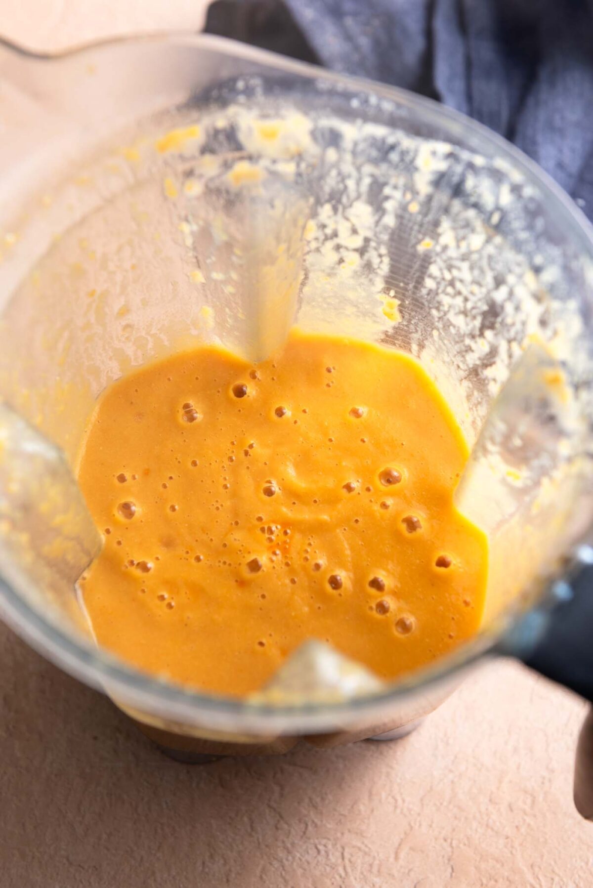 Blended creamy curry soup in a blender container.