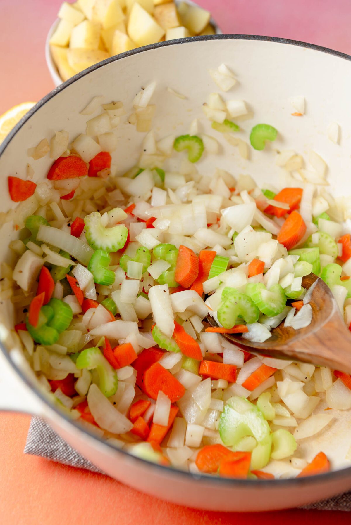 Chopped celery, onion and carrot cooking in a soup pot.