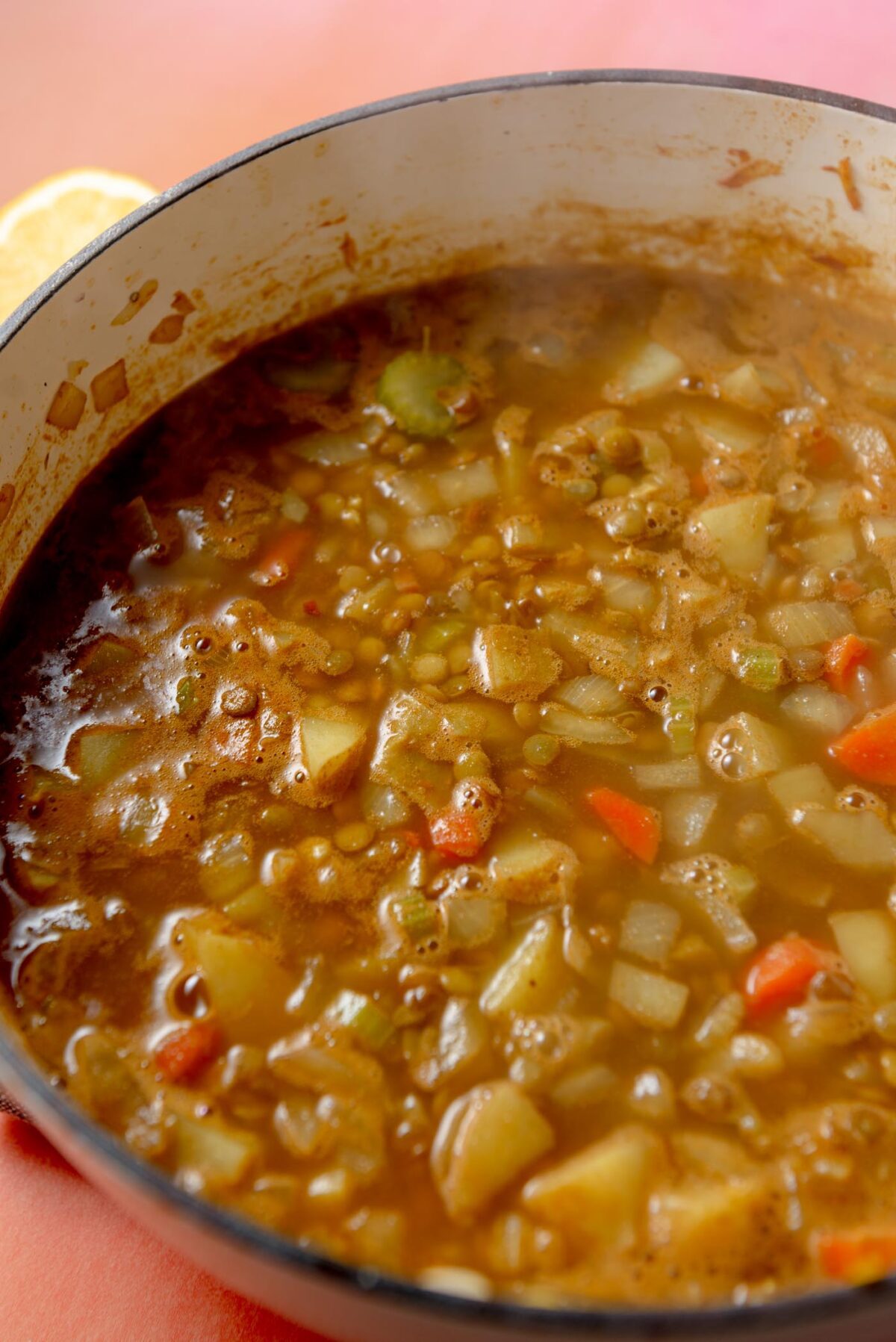 Potato lentil soup cooking in a large pot.
