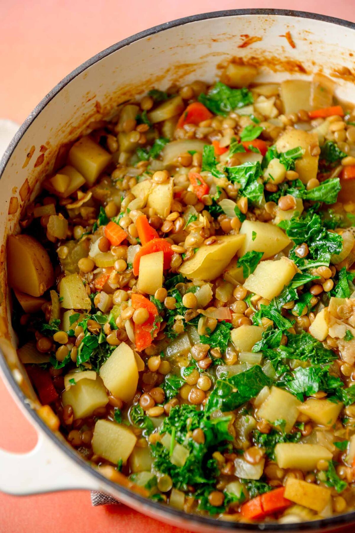 Kale potato and lentil soup in a large pot.