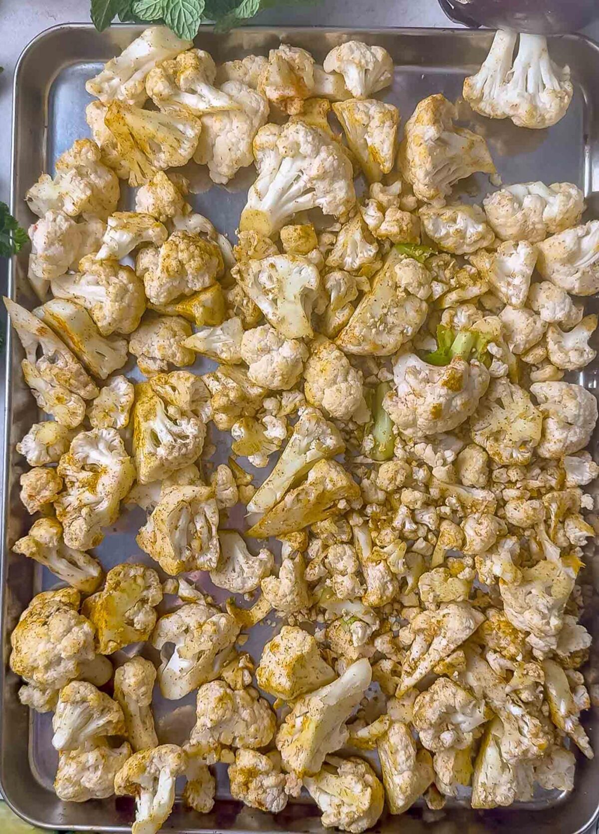 Roasted cauliflower on a baking sheet.