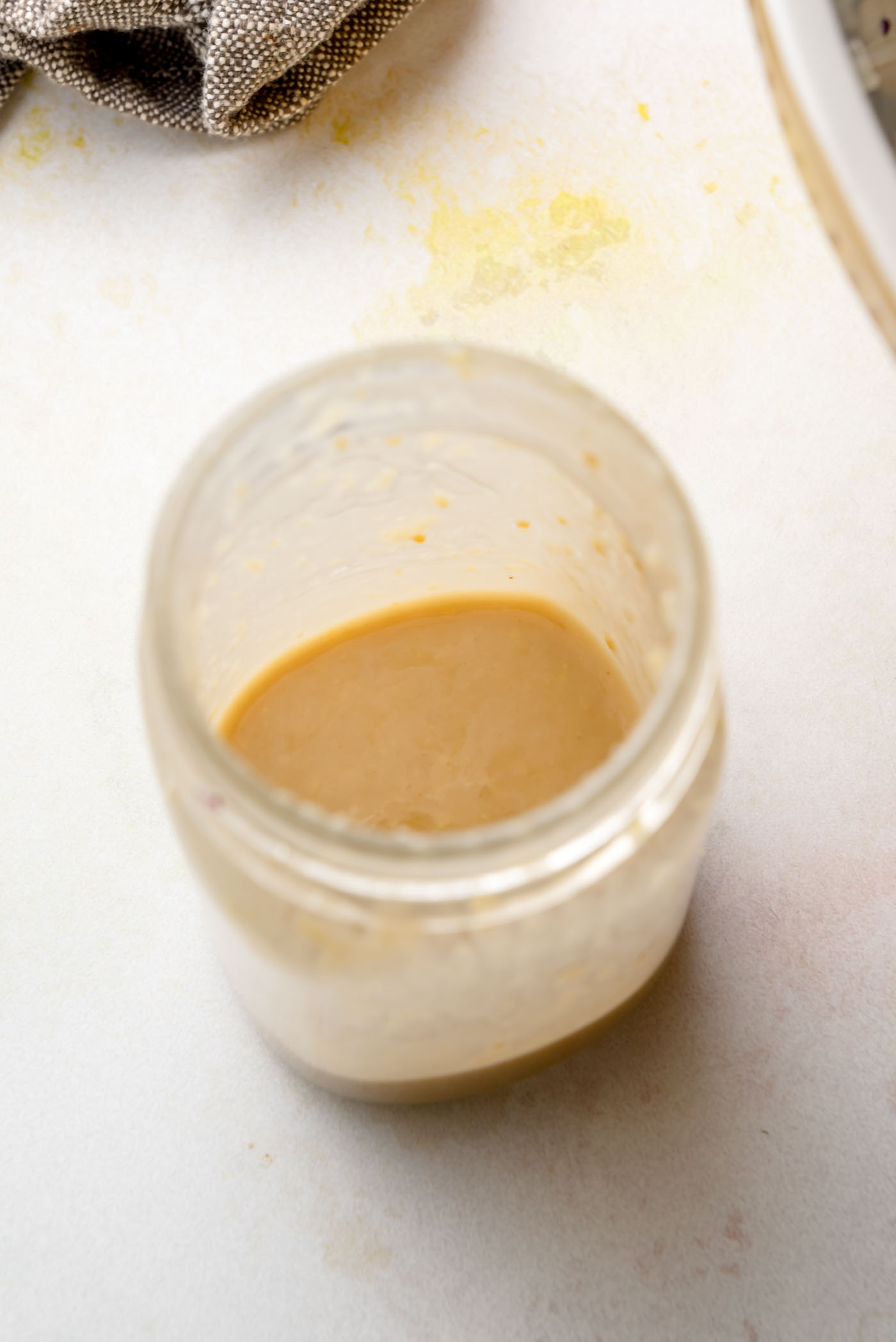 Creamy miso sesame dressing in a glass jar, made with tahini, miso, ginger and garlic.
